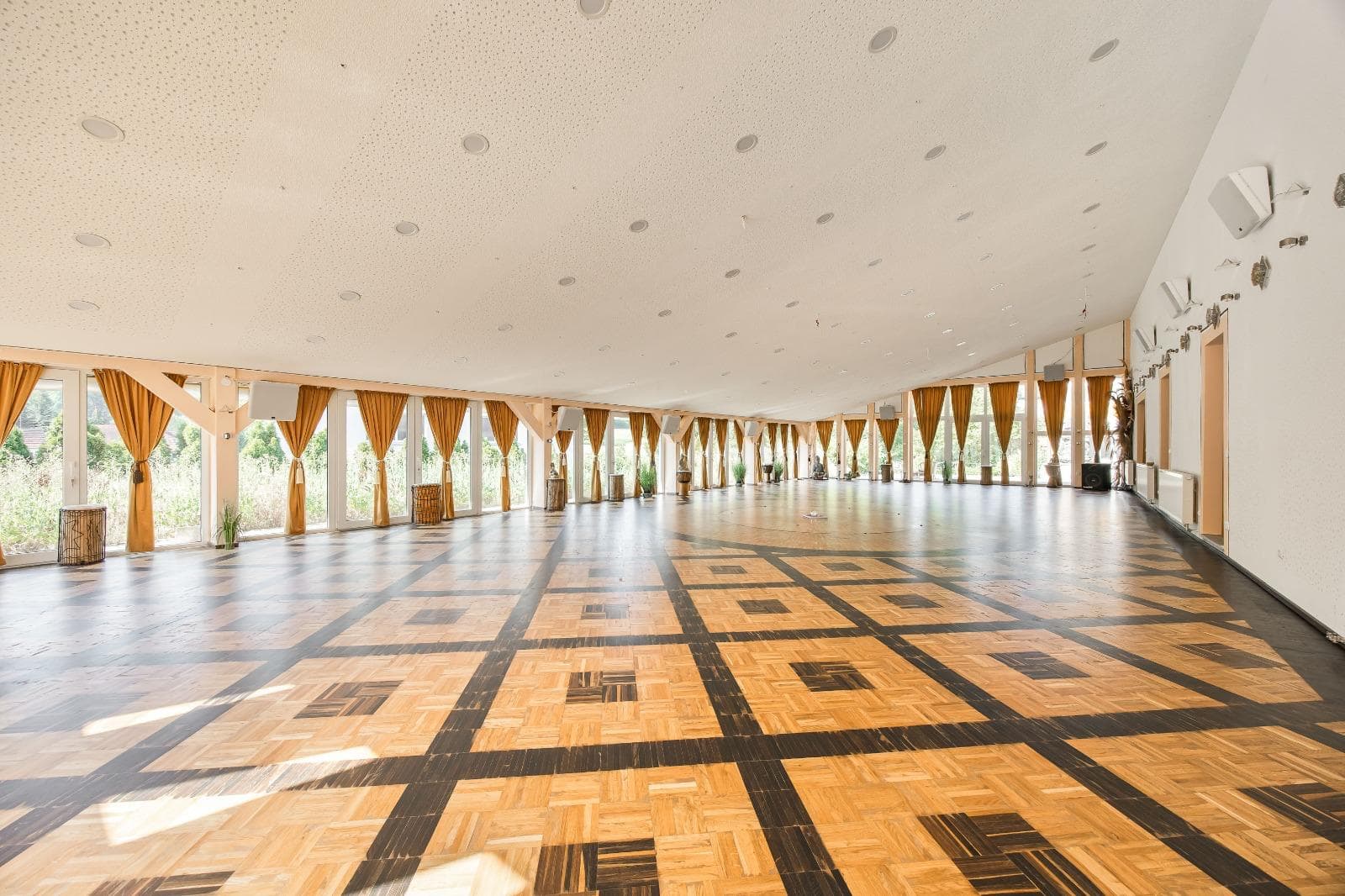 The grand hall with parquet floor and golden curtains