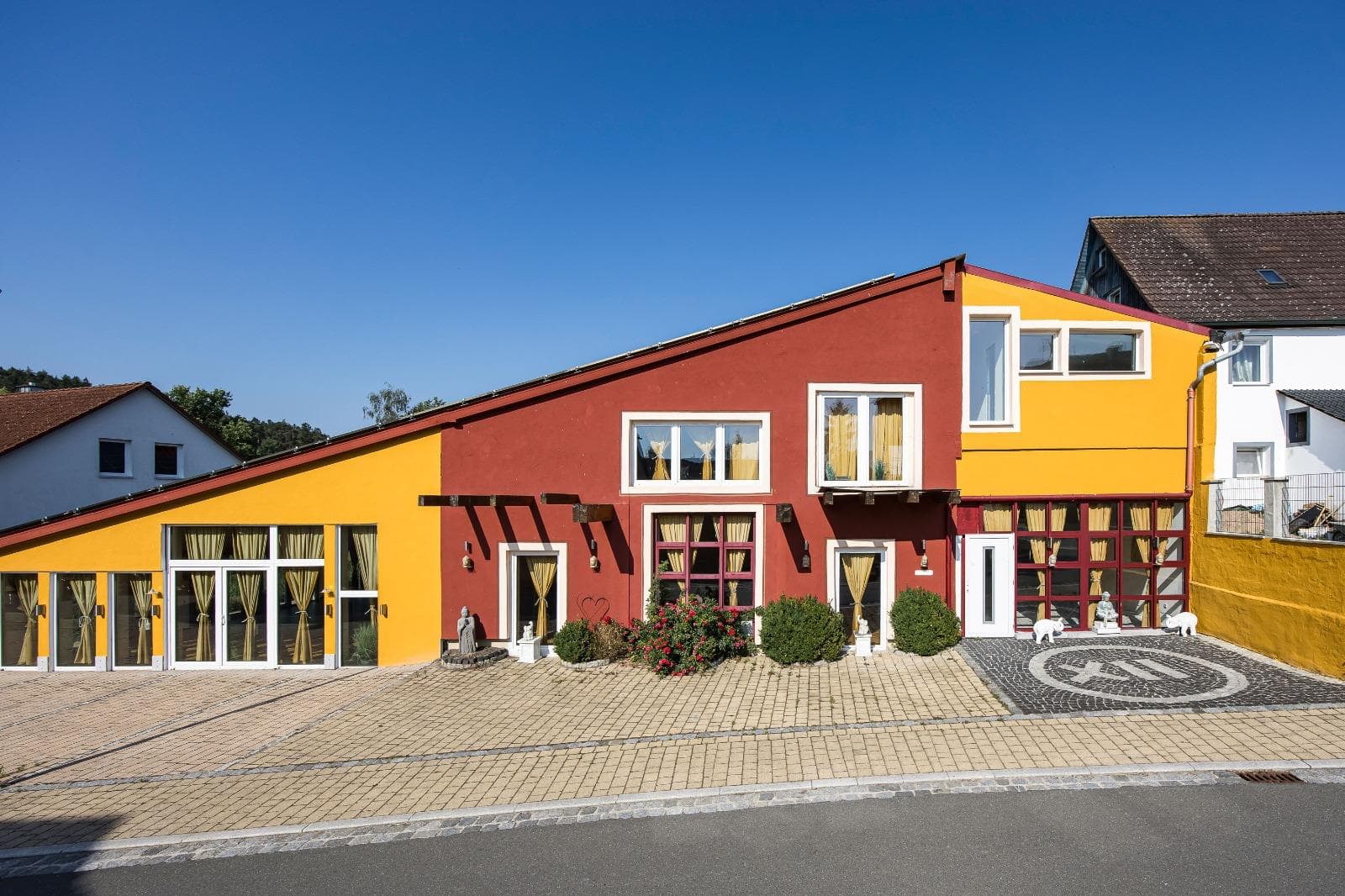 The red-and-yellow façade of Punkt XII from a bird's-eye view