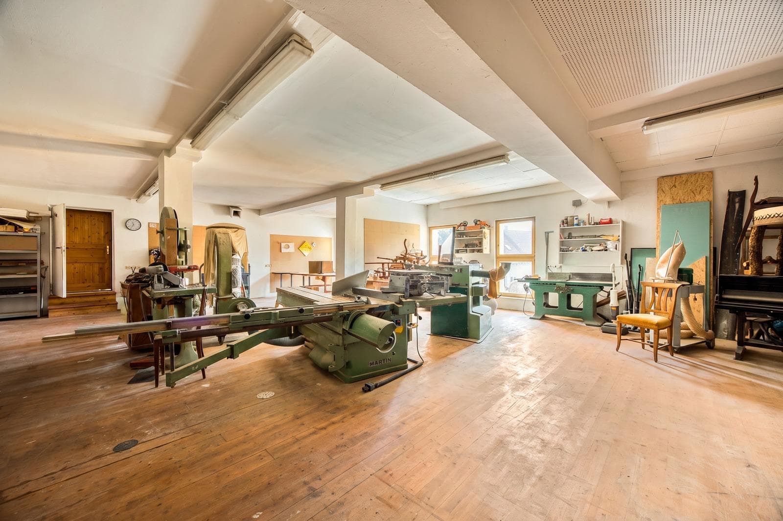 Large bright seminar room with a wooden floor and plenty of daylight