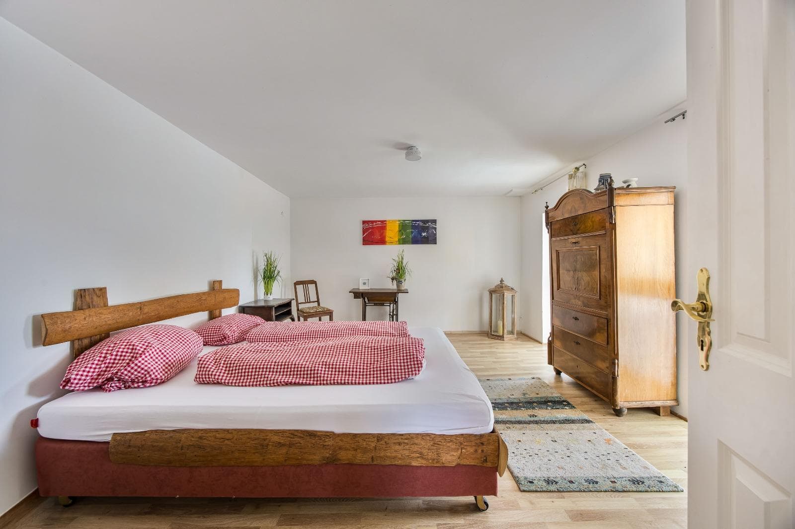 Cosy guest room with wooden furniture and warm linens at Punkt XII