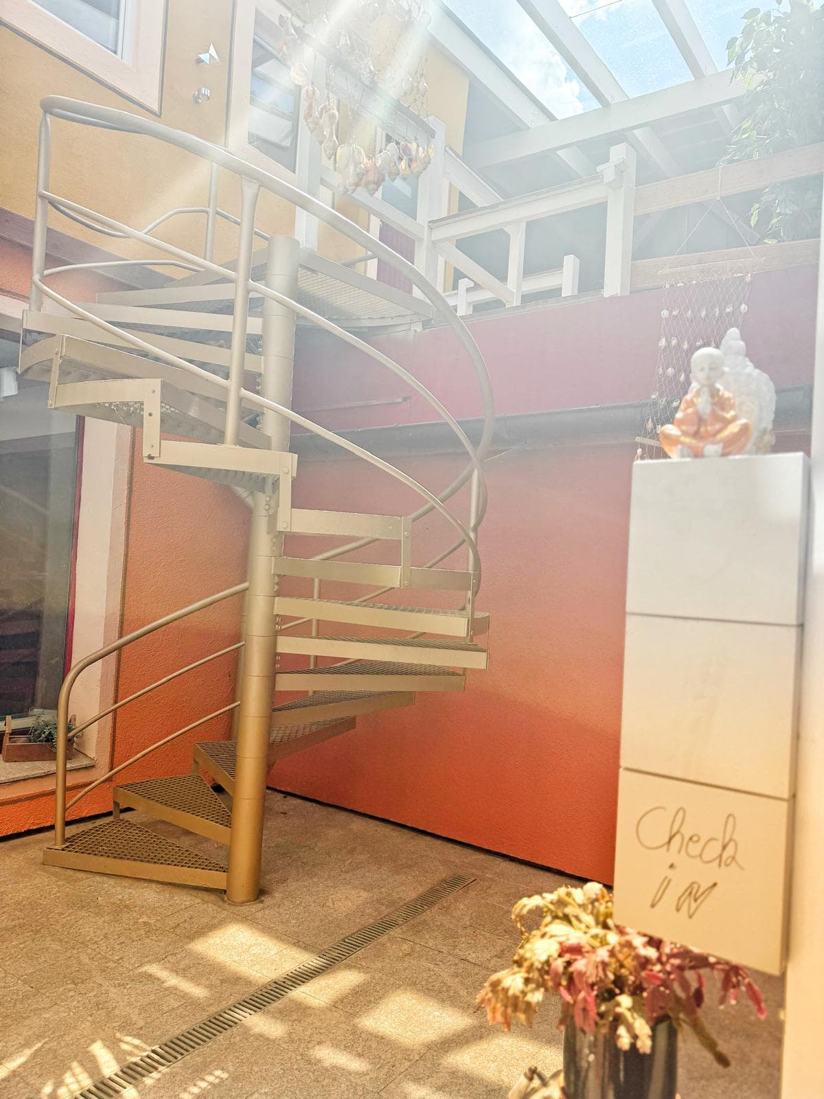 Goldene Wendeltreppe im gläsernen Wintergarten